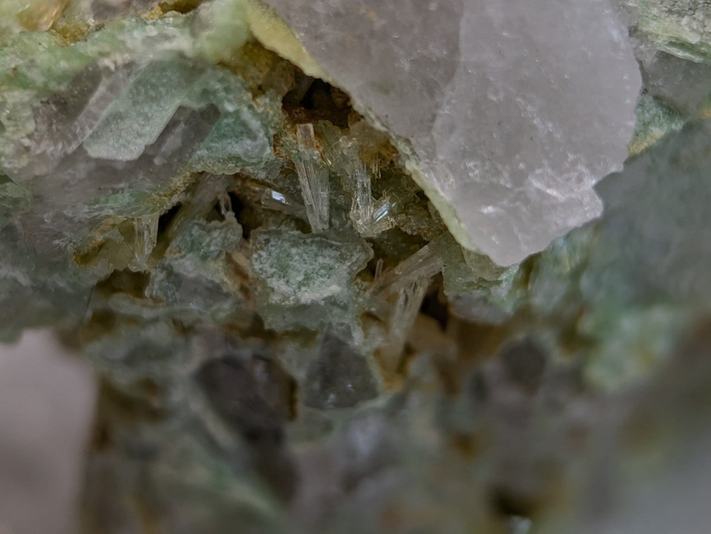 A cluster of translucent pale green and white wavellite crystals on variscite matrix from polk county arkansas