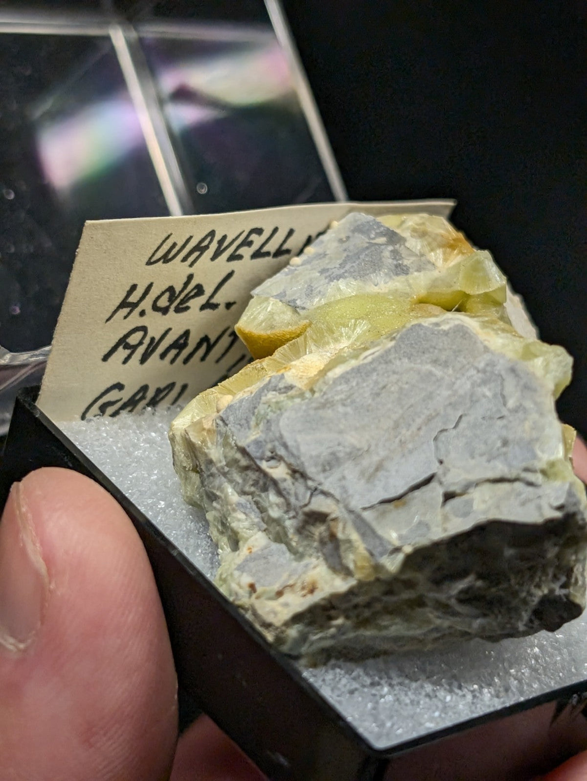 A gray and yellow mineral specimen with a rough, jagged surface.