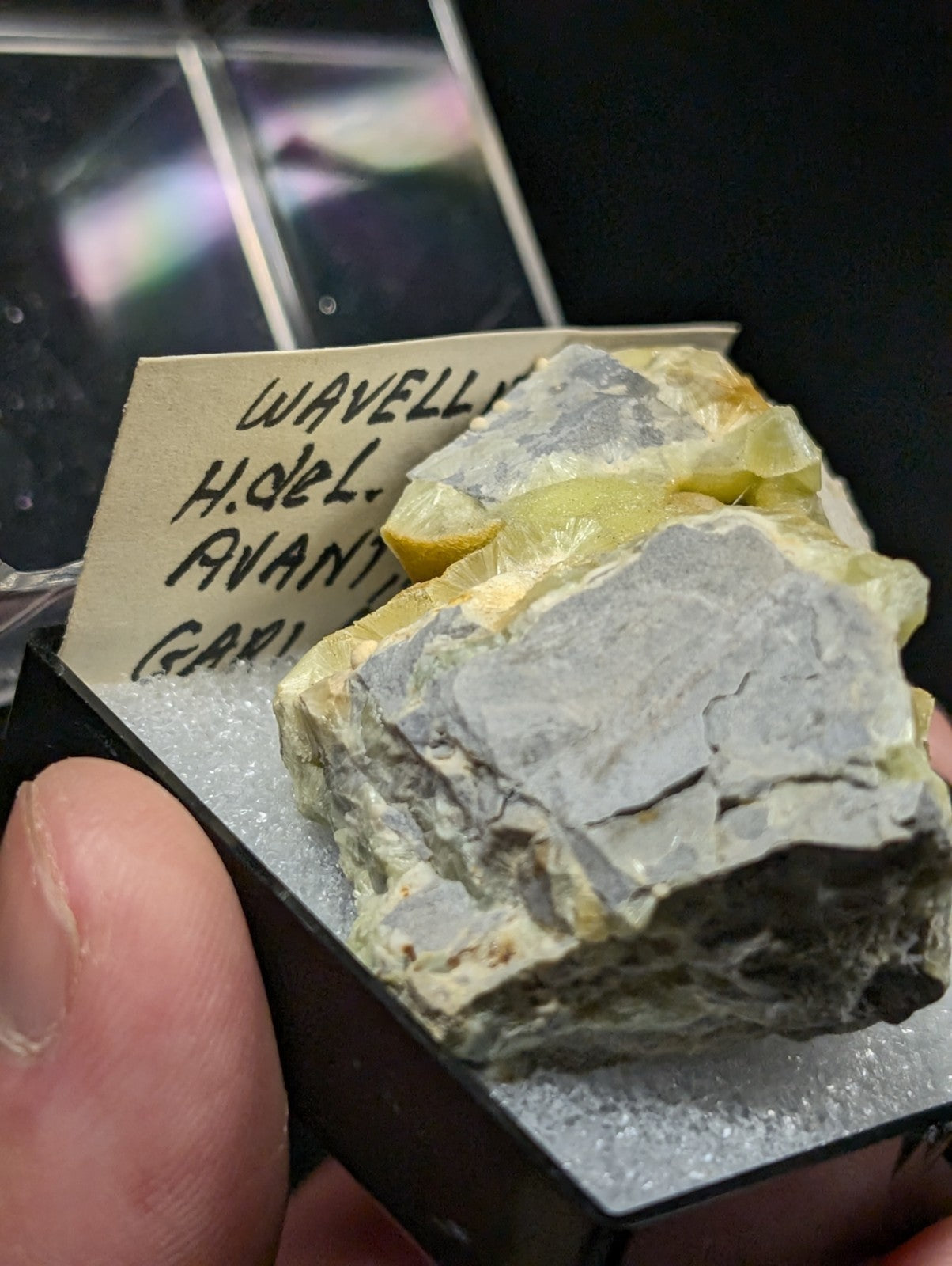 A gray and yellow mineral specimen with a rough, jagged surface.